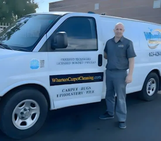 Wharton Carpet Cleaning technician smiling in front of a service van in Phoenix, AZ